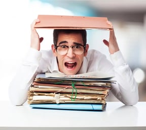 FI-stressed-man-looking-mountain-folders-screaming.jpg