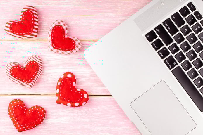 valentines-desktop-decoration-with-red-handmade-sewed-heart-gift-laptop